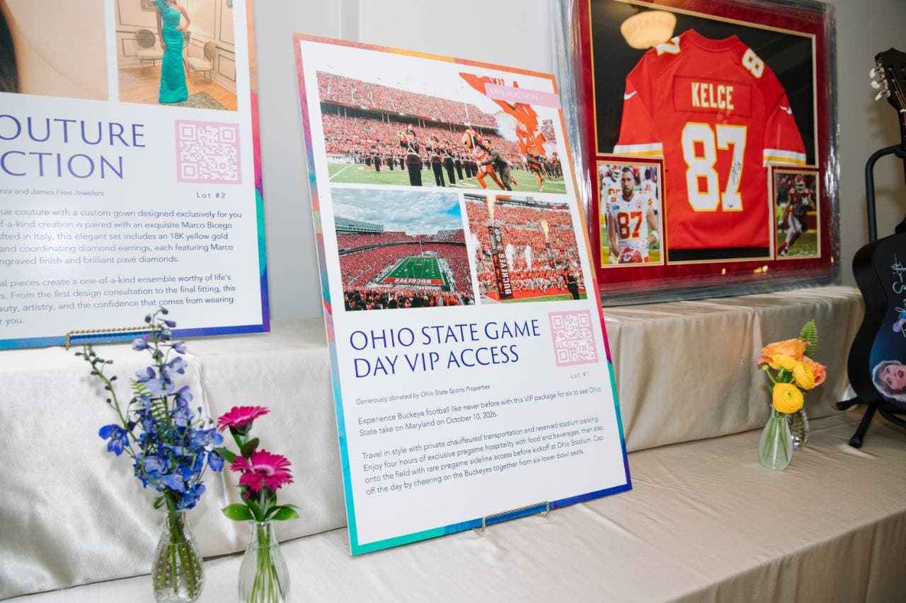 Printed auction board describing an Ohio State game-day package with photos and a QR code