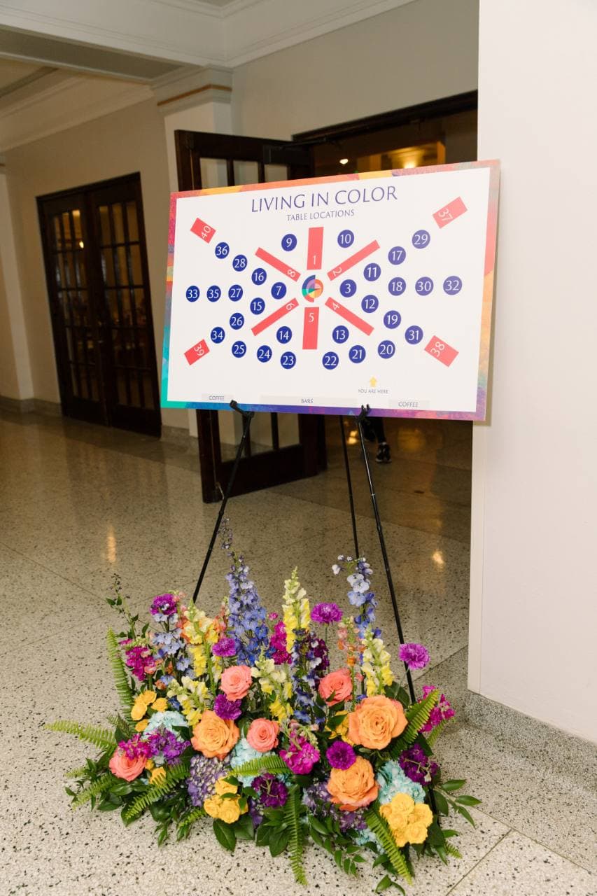 Living in Color printed table-location chart displayed on an easel