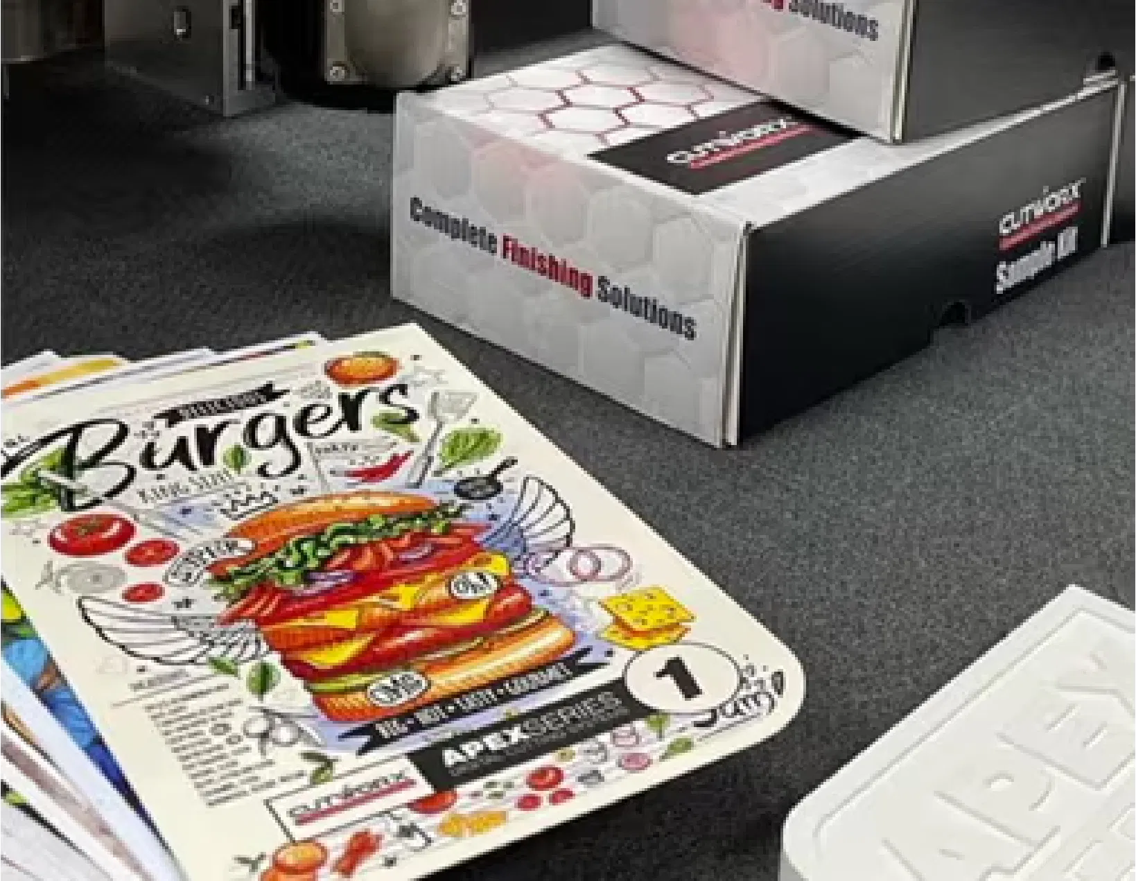 Precision finishing on marketing collateral, showing custom-cut cards and professional-grade output.